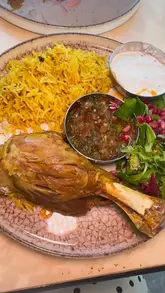 A review video of Monaco Cafe in Manchester, showcasing the interior, drinks, and dinner menu including steak, lamb kabsa, and french toast.