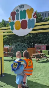 A parent showcases 'Tiny Toon' in Newcastle, a free summer pop-up play space featuring miniature versions of local businesses for children to engage in pretend play.