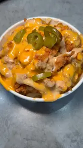 A promotional video for Burger & Sauce featuring a montage of the venue's interior, self-service kiosks, and a variety of loaded burgers and fries. The video focuses on close-up, high-quality shots of the food to highlight the textures and ingredients.