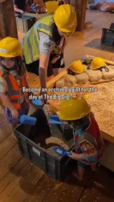 A promotional video for 'The Big Dig' at the London Museum Docklands, featuring children dressed in high-vis vests and hard hats participating in an archaeological dig activity. The video captures the interactive nature of the experience, showing kids digging in sand pits and examining historical artifacts, aimed at families looking for educational activities.