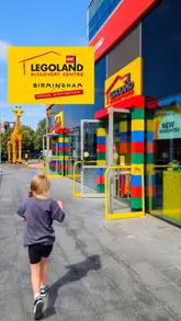 A montage video showcasing a family visit to LEGOLAND Discovery Centre Birmingham, highlighting the interactive play areas, LEGO model displays, and the children's enjoyment of the activities.