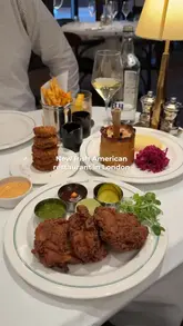 A short, punchy montage showcasing various dishes at Fitzgerald's, an Irish-American restaurant in London, including steak tartare, Caesar salad, fried chicken, and dessert.