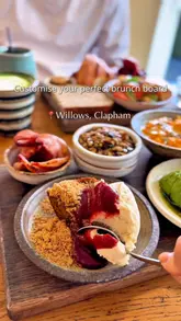 The video showcases a brunch venue in Clapham, highlighting their customisable brunch board concept. It features close-up shots of various small dishes being arranged on a wooden board, including scrambled eggs, avocado, banana bread, and pastries, effectively demonstrating the variety and appeal of the menu.