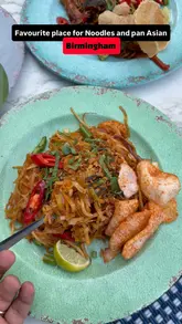 A short montage showcasing various Pan-Asian dishes including noodles, curry, and satay skewers at Banana Tree in Birmingham, followed by an exterior shot of the venue.