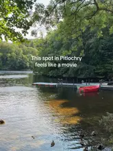 A picturesque, high-quality shot of a lakeside jetty in Pitlochry, capturing a serene and inviting atmosphere that highlights the natural beauty of the location.