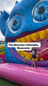 A fast-paced, first-person perspective video showcasing 'The Monster', a large inflatable obstacle course at Bluewater. The video features a participant navigating various sections of the course, including tunnels, climbing walls, and a large slide, effectively demonstrating the scale and physical nature of the activity.