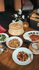A visually appealing showcase of Mei Ume restaurant, highlighting its elegant interior, Cantonese cuisine, and tableside service. The video features a variety of dishes including dim sum, Peking duck, and scallops, set within the sophisticated environment of the Four Seasons Hotel.