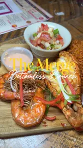 A review of a bottomless brunch at The Merge in Brixton, featuring lobster, prawns, jollof rice, wings, and cocktails.