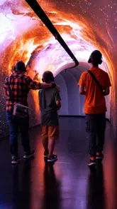 A montage showcasing the Timewalk Exhibition in London, featuring immersive projections and interactive historical displays. The video highlights the experience of walking through different eras, emphasizing the engaging and educational nature of the venue for families and visitors.