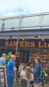 A video tour of Sawers deli in Belfast, showcasing their wide range of imported goods, local products, and deli counter offerings, followed by a brief review of a vegetarian sandwich and baklava.