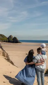 A 47-second travel itinerary reel documenting a 3-day family trip to Swansea, Wales. The video features a montage of clips from various locations including a hotel, beaches, a tropical zoo, a swimming pool, a castle, and several dining spots, structured by day.