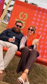 A vlog-style montage capturing a day out at the RHS Sandringham Flower Show. The video features various floral displays, show gardens, and a visit to the Spraga kombucha stand, where the creators sample different flavours and mocktails.