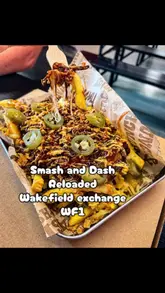 A creator visits Smash and Dash Reloaded in the Wakefield Exchange, providing a review of their loaded fries and pizza. The video includes shots of the menu, the venue's seating area, and close-ups of the food being eaten.