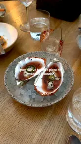 A short, aesthetic reel showcasing a Mediterranean-style restaurant in London called Pyro. The video features a walk-in shot, interior atmosphere, and close-ups of various dishes and drinks, emphasizing a 'Mykonos' vibe.