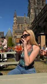 A short, engaging video showcasing The West End Garden in Edinburgh, an outdoor pop-up venue located on the grounds of St Mary's Cathedral. The video features the creator enjoying a spritz and pizza, highlighting the relaxed atmosphere, menu options, and the scenic location.