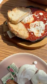 A creator visits Cozy Corner Cafe in Newry, highlighting its beautiful courtyard and breakfast menu, comparing the atmosphere to the Amalfi Coast.