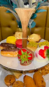 A short, aesthetic montage showcasing an afternoon tea service at Haute Dolci, featuring close-ups of the tiered stand, tea pouring, and interior decor.