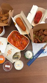 A family vlog-style reel documenting a visit to Bunsik at the Trafford Centre, featuring shots of the venue exterior, the ordering process, and a spread of Korean street food enjoyed at home.
