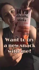 A creator reviews La Vie spicy vegan salami sticks, sharing their initial reaction to the taste and texture, ultimately recommending the product despite a slight aftertaste.