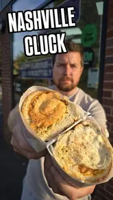 A food review vlog featuring a creator visiting The Nashville Cluck to try their new chicken bodega subs. The video includes shots of the venue exterior and close-ups of the food, followed by a taste test in a car.