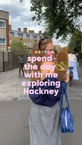 A 'day in the life' style vlog showcasing a trip to Hackney, London, featuring visits to Victoria Park, local markets, coffee shops, bagel spots, and flower markets.