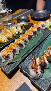 A short, music-led montage showcasing a visit to a Japanese restaurant, featuring shots of the exterior, the dining area, and various dishes including sushi, ramen, gyoza, and karaage.