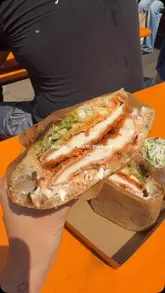 A short, handheld video showcasing a chicken parm sandwich, focusing on the texture and ingredients.