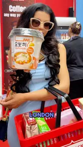 A creator visits the Uni Snacks stall at the Hyper Japan festival, showcasing a wide variety of Japanese and Korean snacks, drinks, and frozen food products, including taste tests of noodles and chicken.