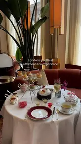 A sophisticated and inviting shot of an afternoon tea service at The Chancery Rosewood in Mayfair. The image features a classic tiered stand, fine china, and a glass of champagne, set against a warm, upscale interior, effectively communicating a luxury dining experience.
