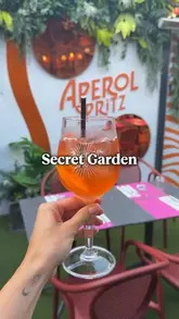 A short, engaging video review of the 'Secret Garden' at Saba restaurant on Baggot Street, Dublin. The creator highlights the outdoor seating area, showcases an Aperol Spritz, and presents several dishes including crispy pork belly, squid, fan fo, and crispy chilli chicken, while mentioning a summer set menu offer.