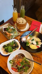 A montage video showcasing various Vietnamese dishes at Viet Food in London's Chinatown, including close-ups of grilled beef, summer rolls, scallops, and fried rice, alongside shots of the kitchen and restaurant interior.