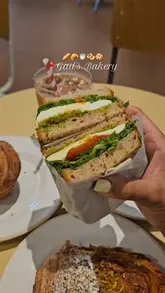 A short, handheld video showcasing various pastries, a sandwich, and an iced coffee from Gail's Bakery, highlighting the freshness and appeal of the menu items.