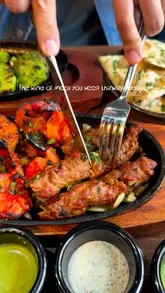 A montage of Indian cuisine and cocktails at Sky Bar & Grill in Leeds, featuring close-up shots of sizzling platters, naan, and drinks.