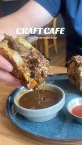 A short review of Craft Cafe in Belfast, featuring close-ups of their brunch dishes, including a beef dip sandwich and poached eggs, alongside iced drinks and a tour of the cafe's interior and outdoor seating.