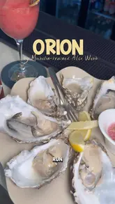 A couple visits Orion in Wimbledon, showcasing their oyster happy hour and a full dinner menu, highlighting the high-quality presentation and dishes created by a MasterChef winner.