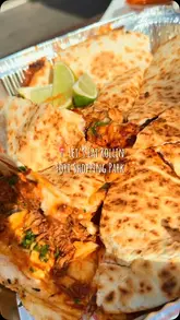 A short promotional video for a food truck called Let's Eat Rollin located at Fort Shopping Park, showcasing their birria quesadilla, pizza, and tacos served with consommé.