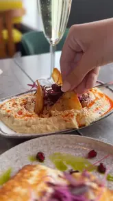 A montage showcasing the interior and new menu items at The Sultan, a Turkish and Mediterranean restaurant in Cardiff Bay. The video features close-ups of various dishes including flatbread, dips, halloumi, and a mixed grill platter, alongside shots of the restaurant's dining area.