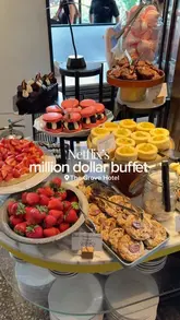 A montage video showcasing the extensive and high-quality buffet spread at The Grove Hotel, featuring a wide array of seafood, sushi, roasts, and desserts, alongside shots of the hotel's exterior and dining area.