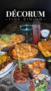 A polished promotional montage showcasing the interior, cocktails, and various dishes at Decorum restaurant, highlighting the upscale atmosphere and food presentation.