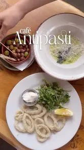 A promotional reel for Café Antipasti in Glasgow, featuring a montage of various Italian dishes, drinks, and the restaurant's interior and exterior. The video uses a clean, edited style with text overlays highlighting the venue's long-standing history and value.