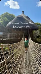 A fast-paced montage showcasing the various play structures, rope bridges, slides, and water features at Windsor Great Park Adventure Play, featuring a child exploring the park.