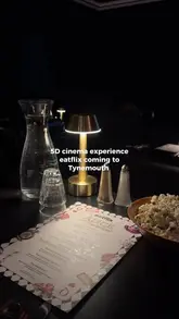 A promotional video for 'eatflix,' a 5D cinema experience in Tynemouth where guests are served food and drinks that correspond to the movie being screened, specifically showcasing an Alice in Wonderland themed menu.