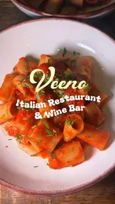 A montage of food and drink items at Veeno, including parmigiana, cocktails, pasta, burrata, and tiramisu.