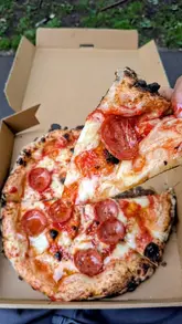 A short, energetic video featuring a couple visiting a pizza truck in Glasgow. The video highlights the menu, the wood-fired cooking process, and the final product, showcasing the pizzas being enjoyed outdoors.