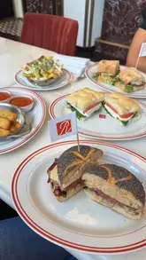 A fast-paced vlog following a creator through a food-focused day in London, visiting Ronnie's for deli-style sandwiches, Ice Cream Union for dessert, and Firebird for a dinner of small plates and steak.