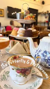 A montage-style video showcasing the interior and afternoon tea service at The Butterfly & Pig, featuring shots of the vintage decor, the menu, and the food spread.