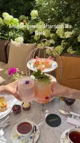 A visually appealing reel showcasing an afternoon tea service at a garden venue in Earl's Court, featuring close-ups of pastries, scones, and bespoke cocktails.