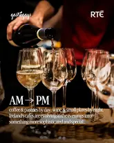 A high-quality, atmospheric image depicting a wine pour, used to promote a feature article about the evolution of Irish cafes into evening venues. The lighting is moody and professional, effectively setting a sophisticated tone for the subject matter.