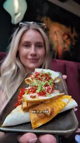 A food review video featuring a creator visiting 'Cilantro' in Newcastle, showcasing the interior, various dishes including butter chicken and chocolate chilli naan, and offering a discount code.