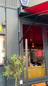 A visual showcase of a Sunday roast menu at Ember Yard, featuring cocktails, a tomato salad, and a large sharing platter of grilled meats and sides.